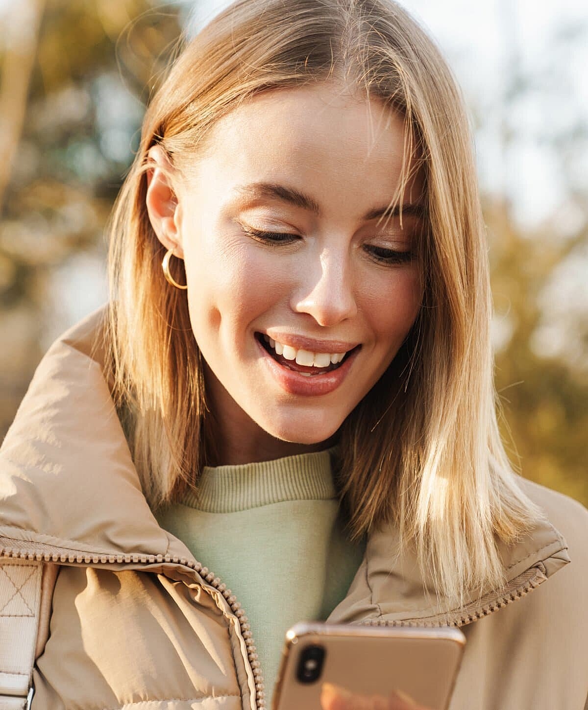 Young woman examining her acne with concern.