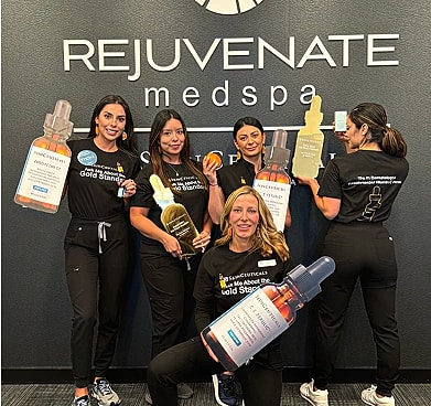Team holding skincare products at medspa.