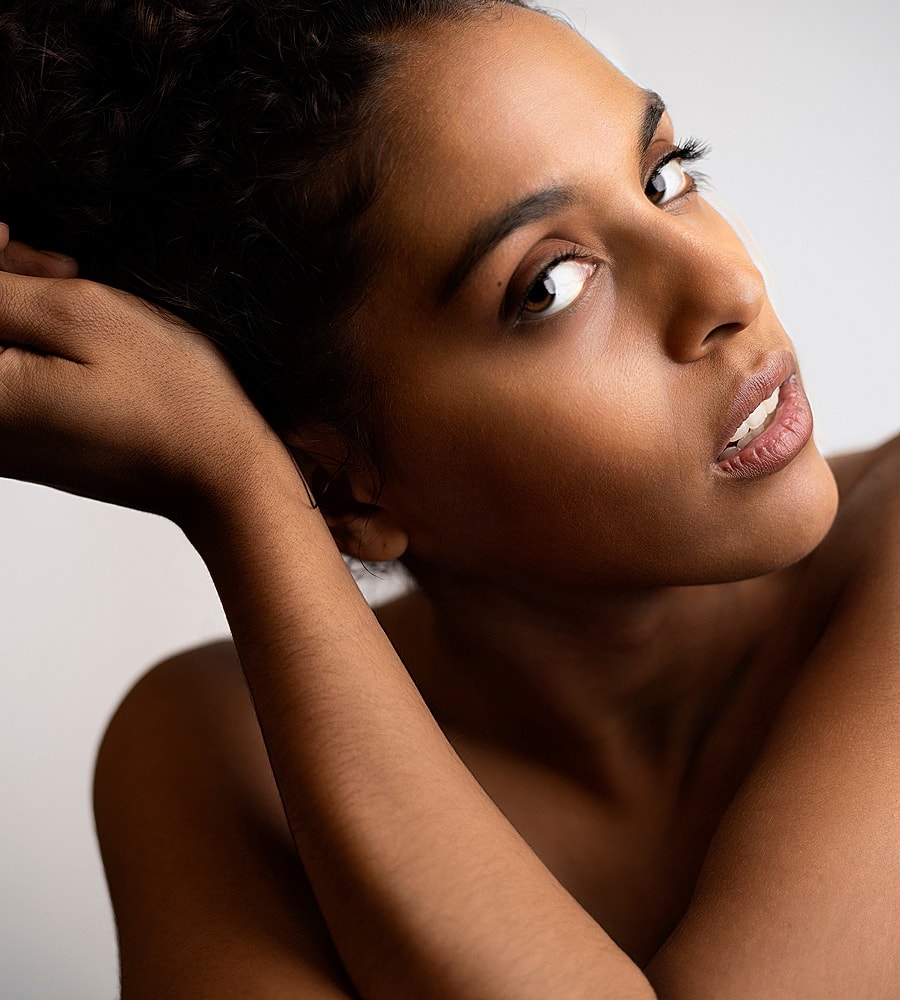 Close-up portrait of a woman with curly hair.