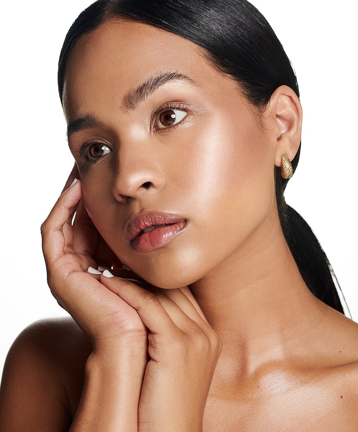 Model with glowing skin and elegant styling.