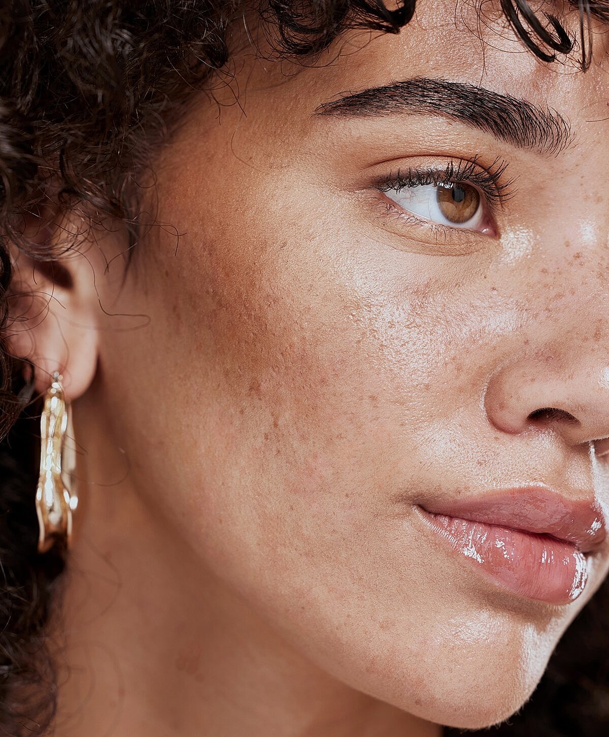 Close-up of a woman’s face and earrings.