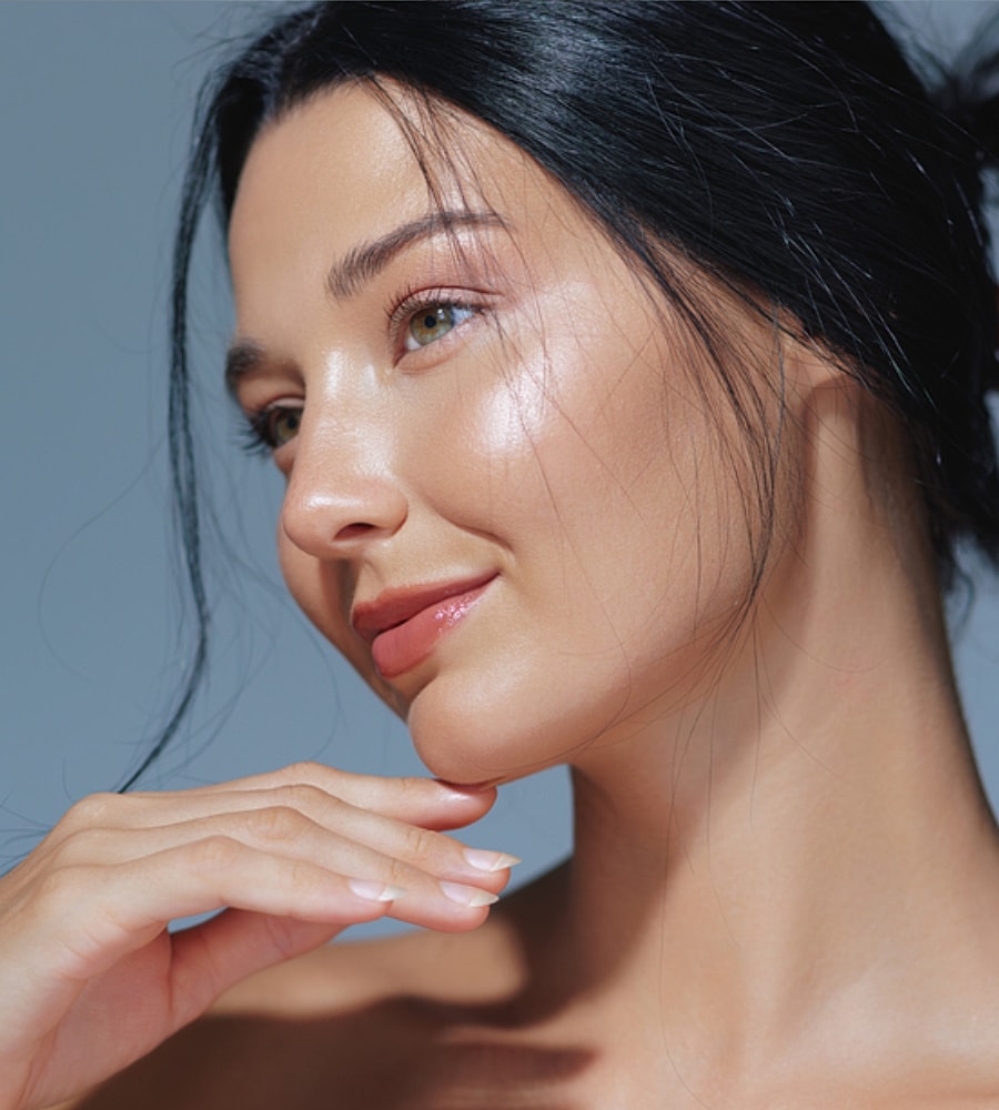 Woman with glowing skin and elegant pose.