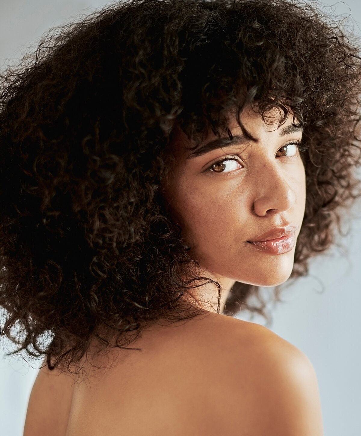 Portrait of a woman with curly hair.