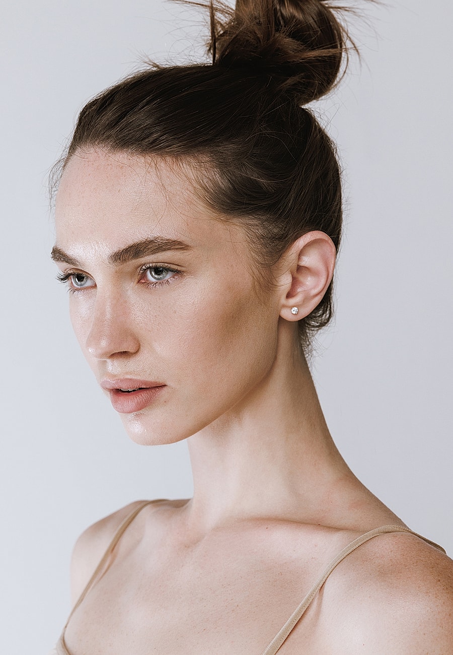 Model with elegant hairstyle and minimal makeup.