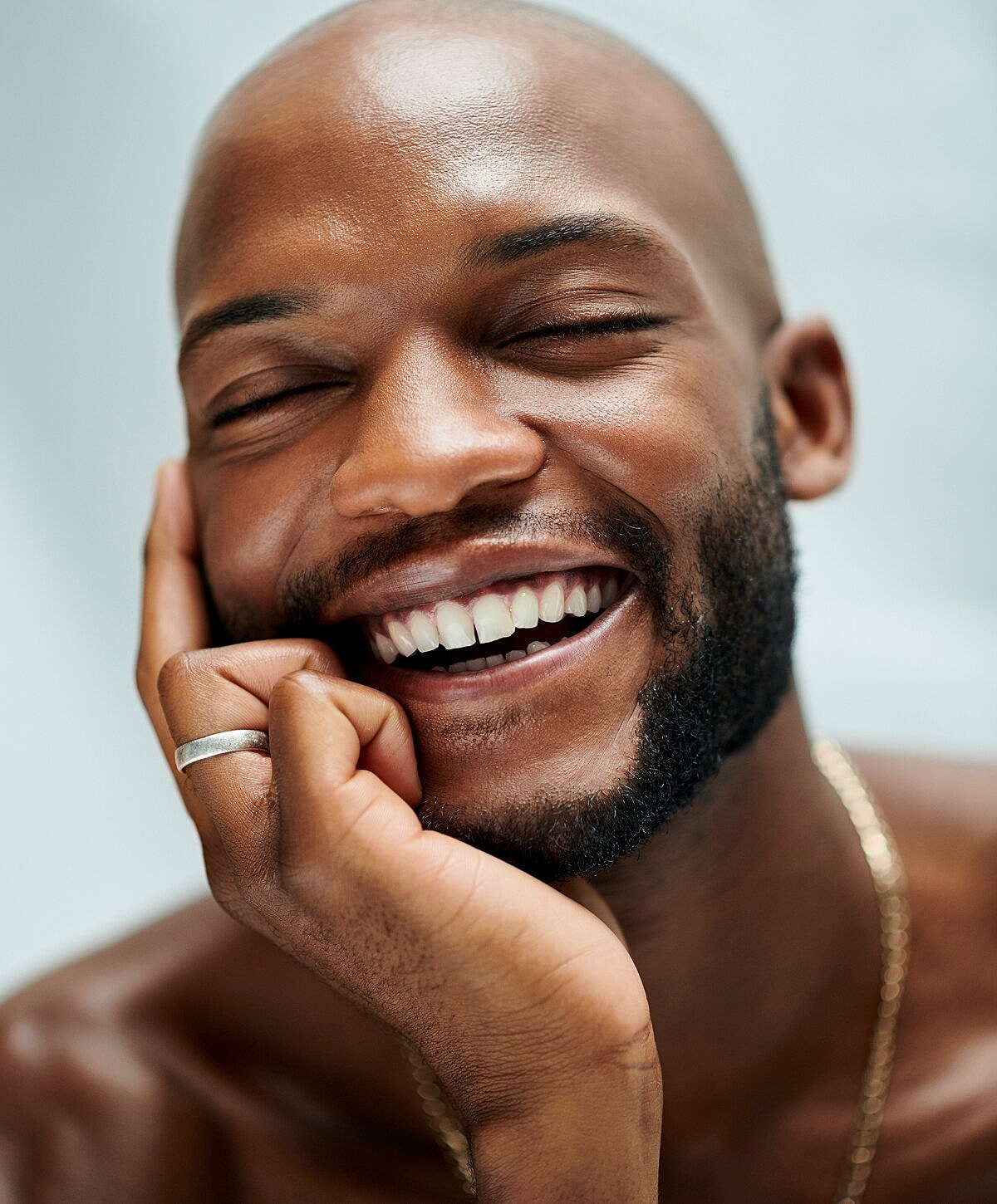 Mountain silhouettes in soft, misty background.
