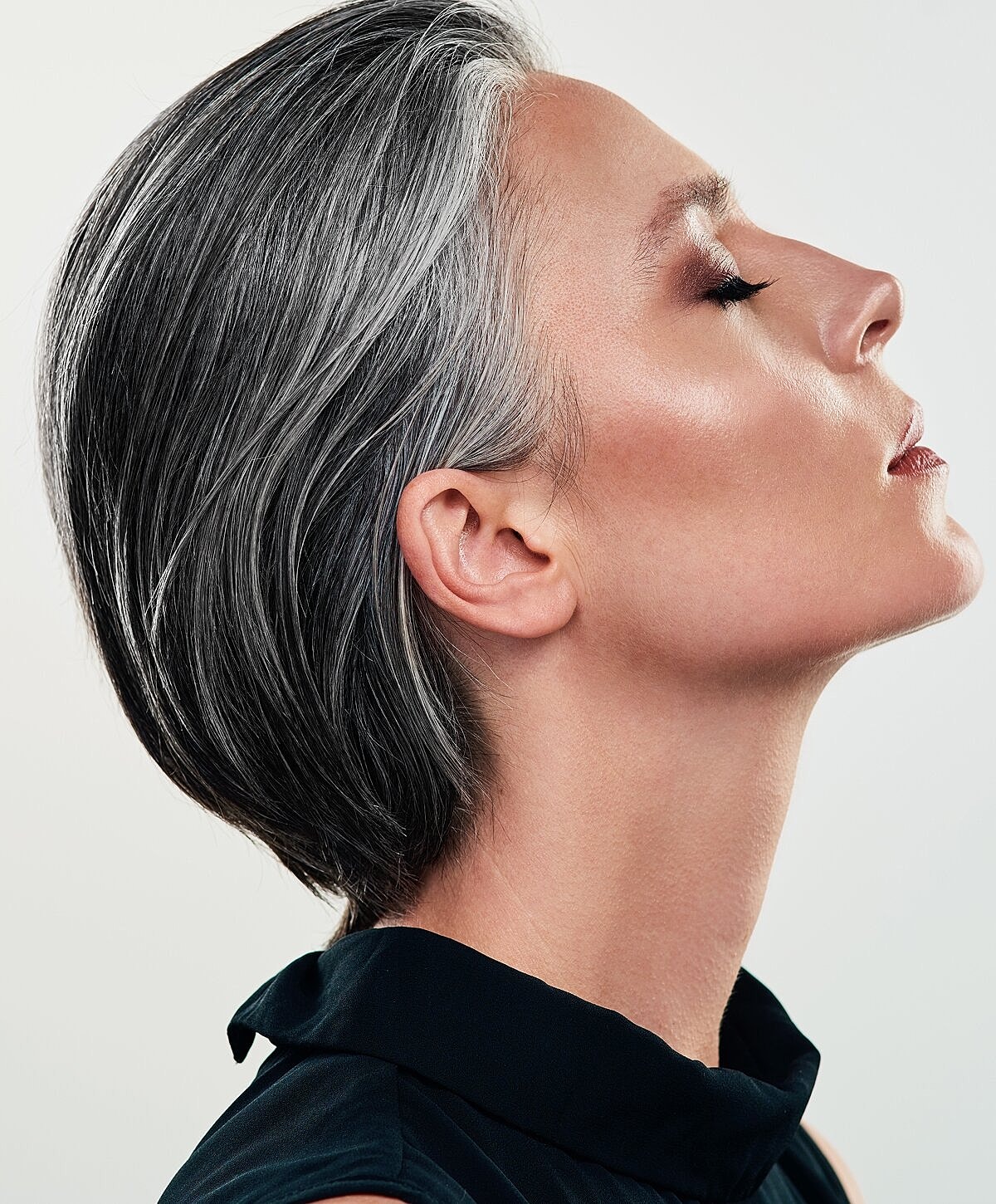 Profile of a woman with elegant gray hair.