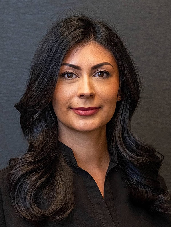 Professional portrait of a woman with dark hair.
