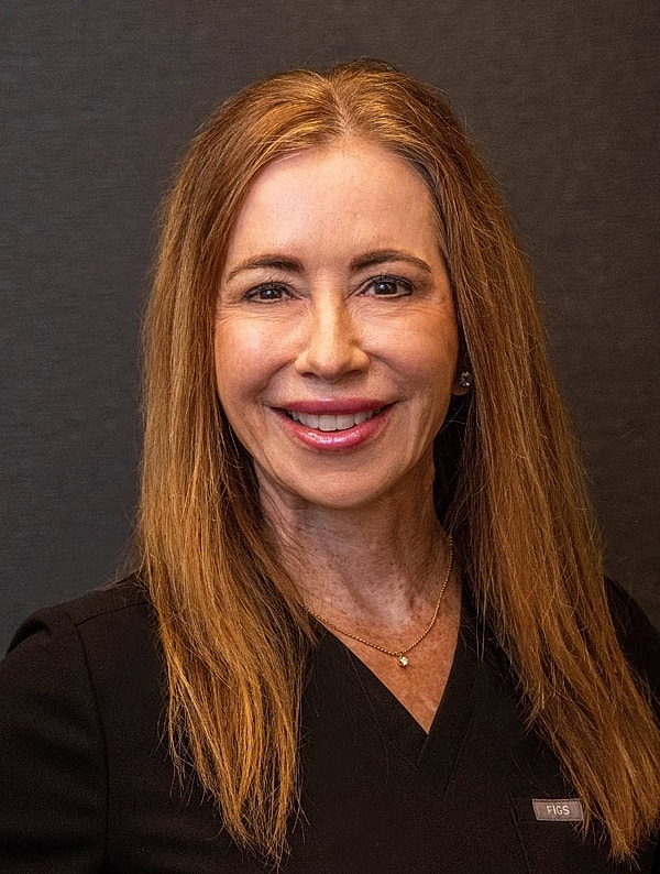 Smiling woman in professional attire.
