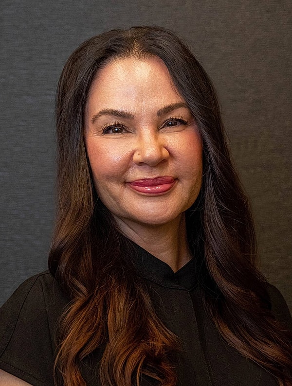 Smiling woman with long, dark hair 