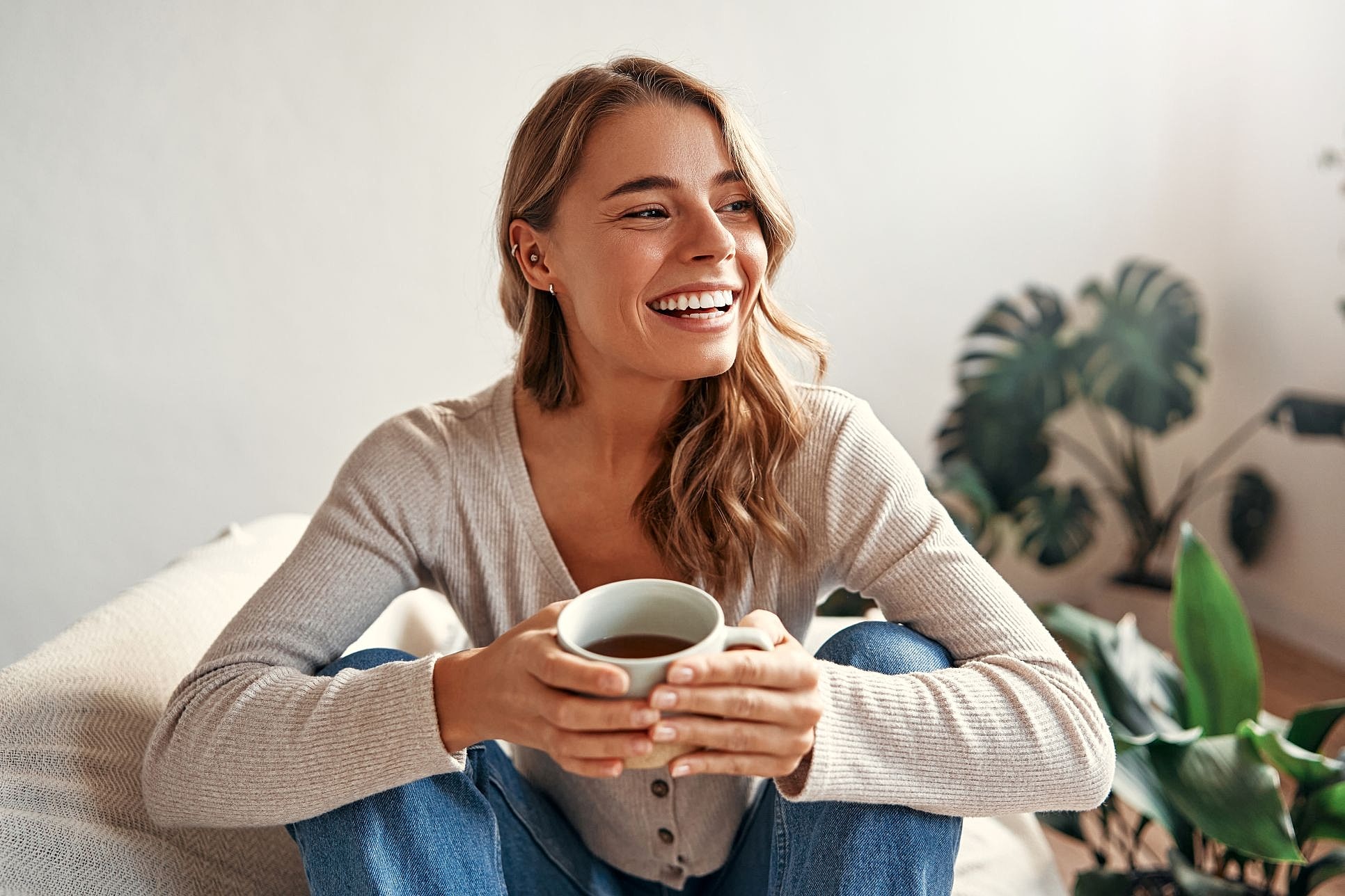 Smiling woman holding a cup of coffee.