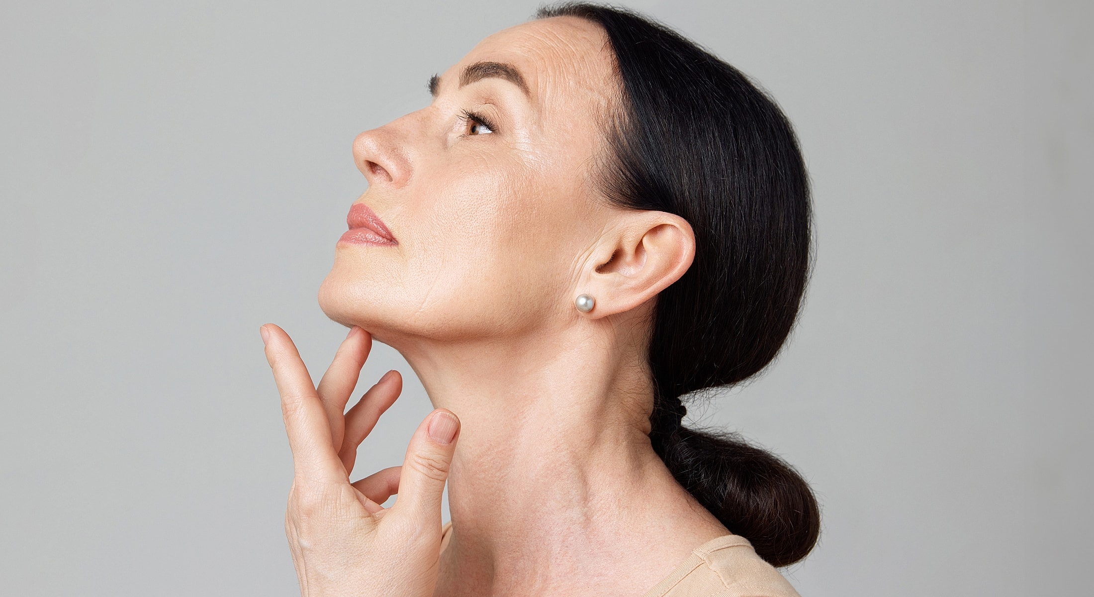 Profile of a woman touching her chin