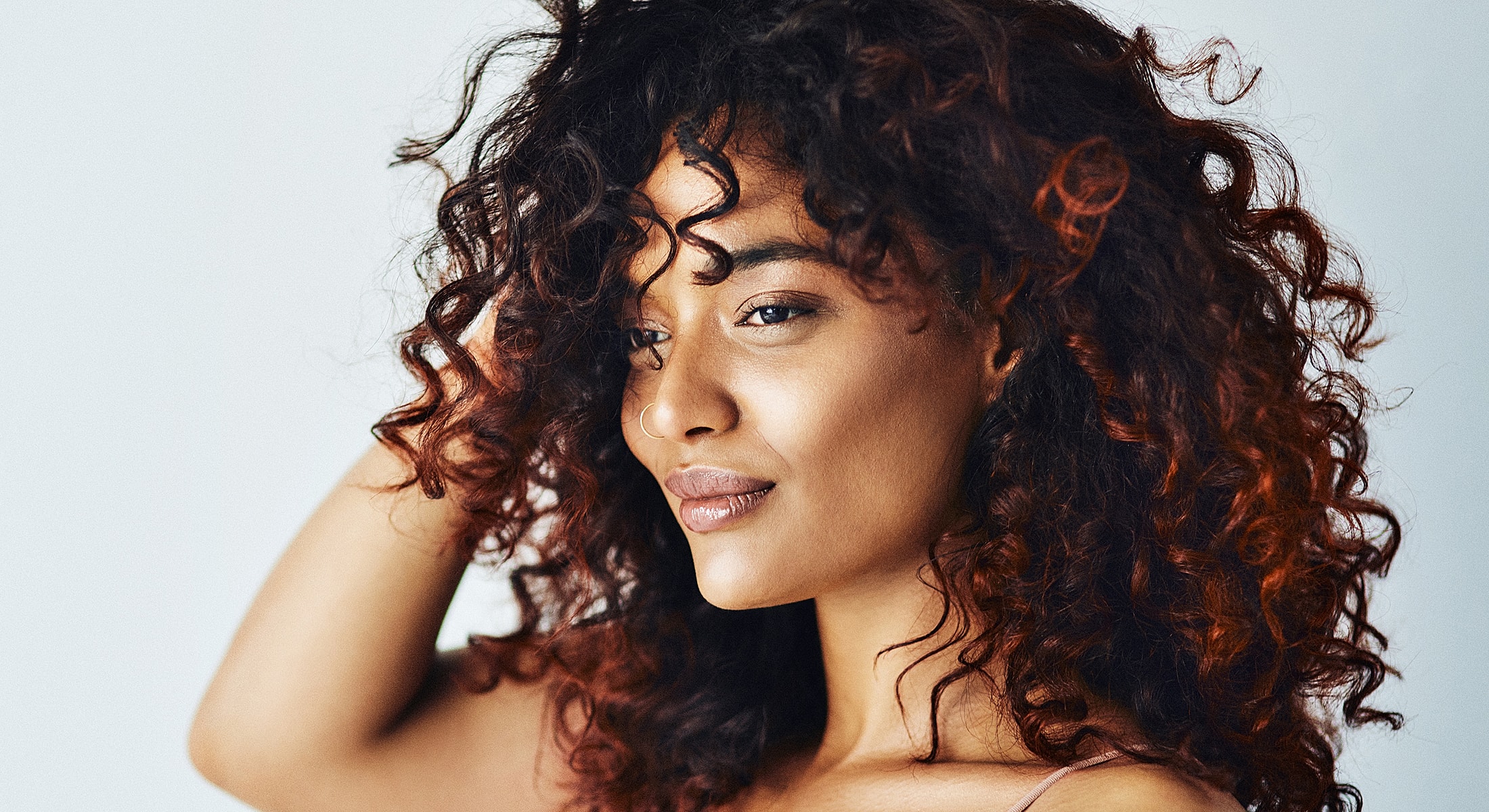 Smiling woman with wavy hair in casual setting